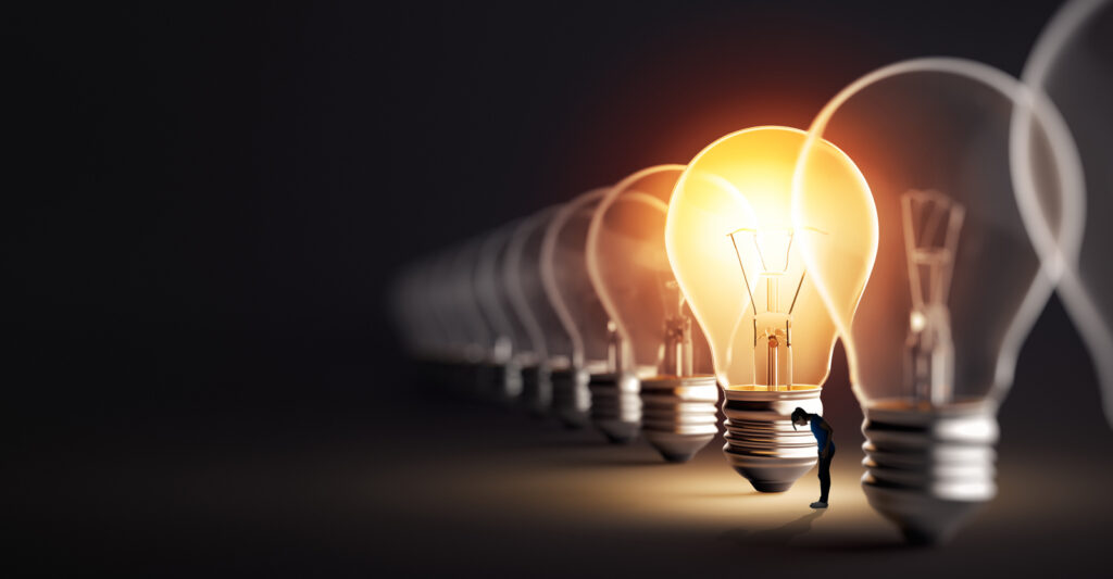 woman looking for something in the light of a lightbulb