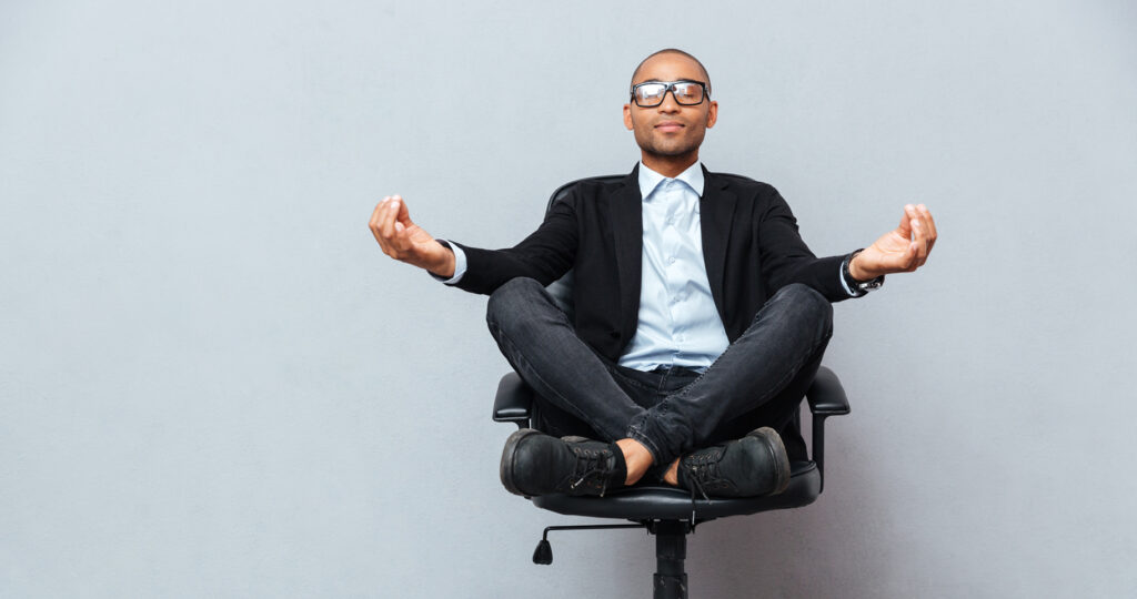 Man meditating in an office chair