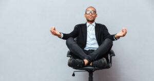Man meditating in an office chair